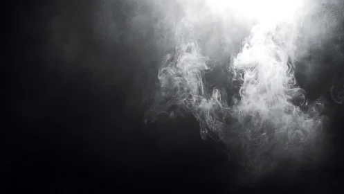 Dense white smoke illuminated against dark background.