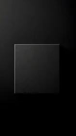 Quiet black square on velvet darkness invites curiosity.
