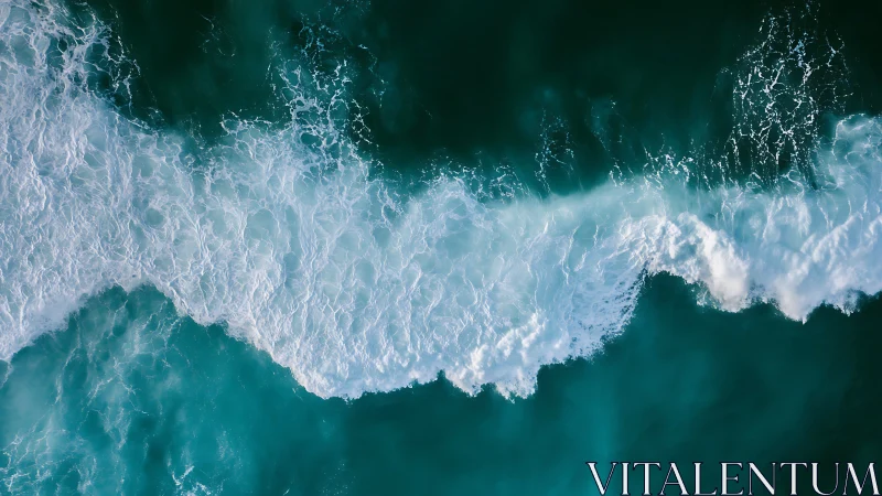 Aerial view of turquoise ocean waves and white surf line
