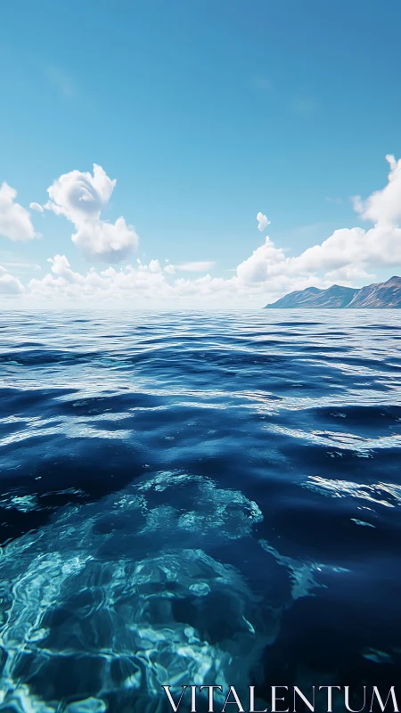 Calm ocean surface reveals submerged rock under clear midday sky