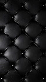 Black tufted leather upholstery with diamond pattern texture.