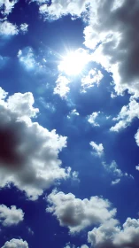Bright midday sun shining through white cumulus clouds.