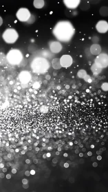 Silver bokeh glitter field glows against dark blurred background
