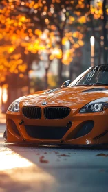 Low-angle autumn streetscape frames vivid orange sports coupe
