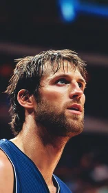Male basketball player in close-up sideline profile view.