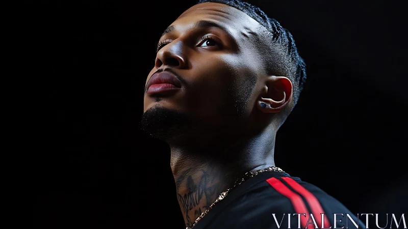 Low-key portrait of pensive man in dramatic profile lighting.