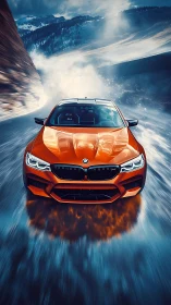 Orange BMW sports car drives fast on wet mountain road
