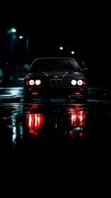 Midnight car waits in glowing reflections on wet streets.