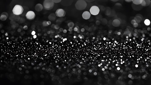 Midnight bokeh constellation over a shimmering dark horizon.