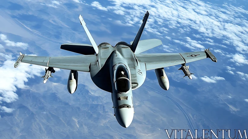 Modern military jet fighter flying high above clouds.