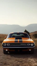 Front view of orange striped classic muscle car outdoors.