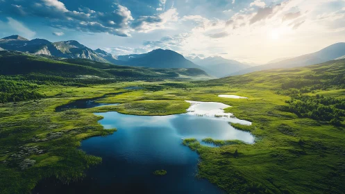 Mountain valley wetlands with reflective blue lakes at sunrise.