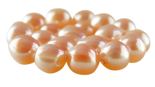 Lustrous peach pearls lie in a softly glowing clustered circle