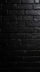 Glossy black brick wall under dramatic side lighting.