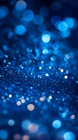 Blue glitter surface shows dense bokeh highlights in macro view