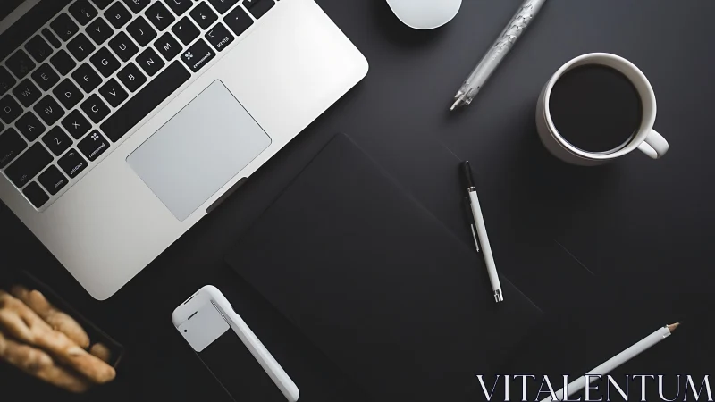 Organized desktop layout with laptop, coffee and devices.