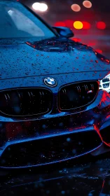 Rain soaked BMW front grille under neon night glow.