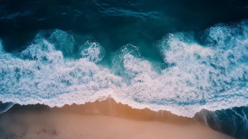 Gentle turquoise surf brushing soft peach evening sand.