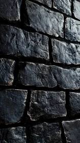 Wet dark basalt brick wall with directional low-key lighting
