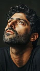 Contemplative man gazes upward in warm dramatic light