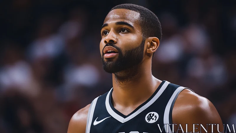 Close-up portrait of focused basketball player in black jersey