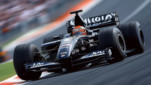 Black open-wheel race car moves on asphalt circuit during event