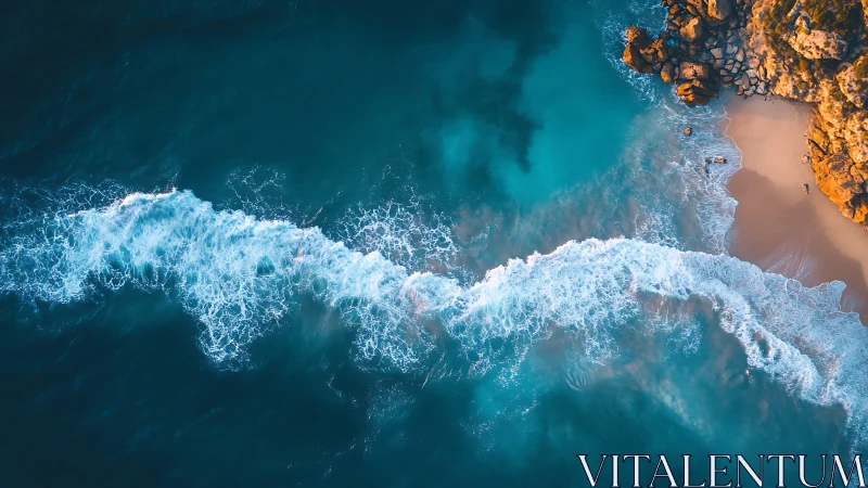 Aerial view captures turquoise surf line curling onto coast