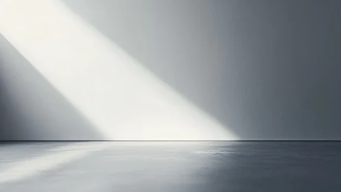 Diagonal light across empty gray interior wall and floor.