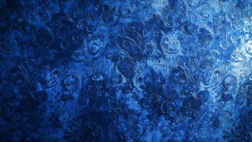 Textured blue surface presents raised ornamental scroll pattern