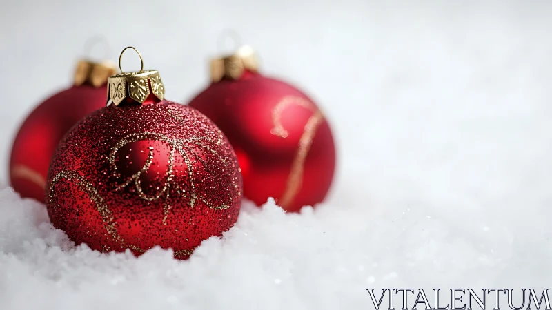 Red Christmas baubles rest in soft snow with festive sparkle