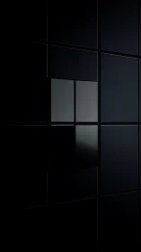 Dark geometric wall with reflective black panel grid.