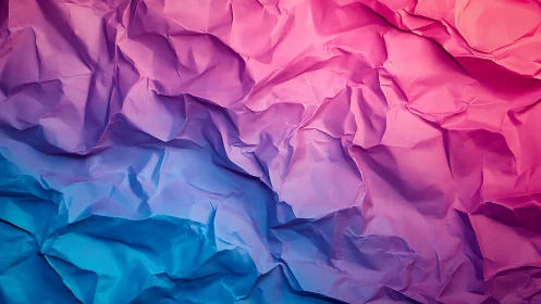 Crumpled gradient paper glows in soft pink and blue light