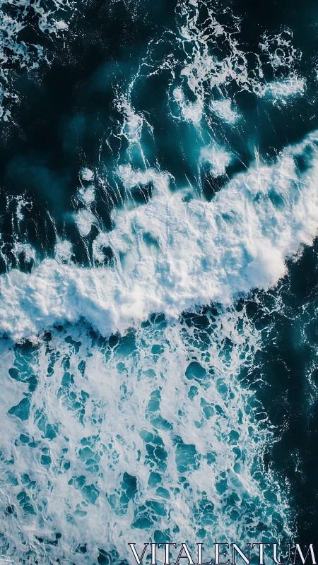 Overhead view of breaking ocean waves and surface foam patterns.