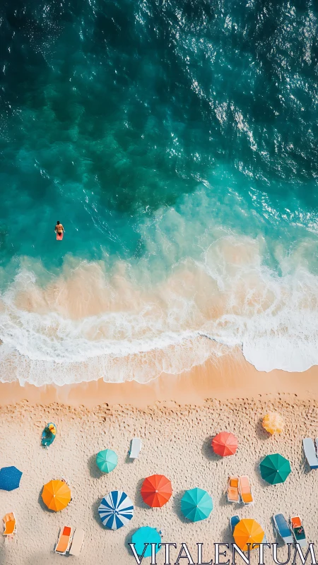 Aerial coastal panorama with sunbathers, umbrellas and shore break