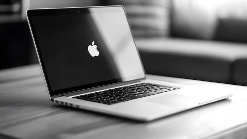 Sleek laptop on wooden table in softly lit workspace.