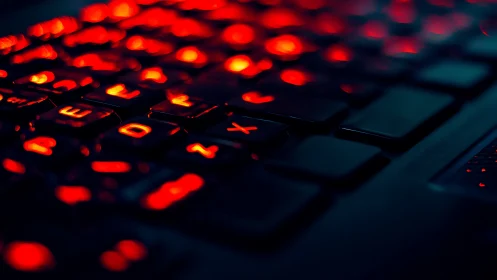 Red backlit keyboard in close-up low light view.
