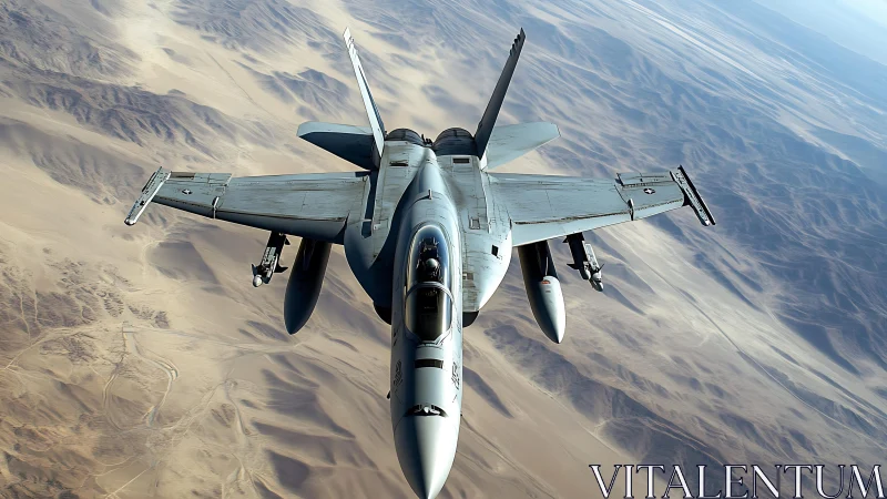 Military jet slices across sunlit desert mountains in flight