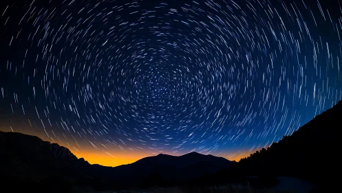Spiraling star trails swirl above calm mountains at dusk