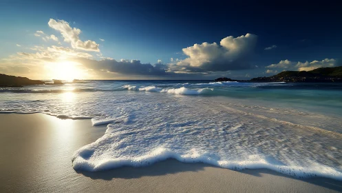 Sunlit ocean waves roll onto quiet sandy shoreline.