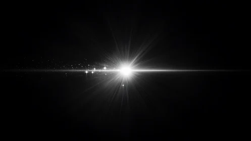 Bright white light burst on black background with rays.