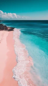 Sunlit pink shoreline under vivid turquoise ocean sky.