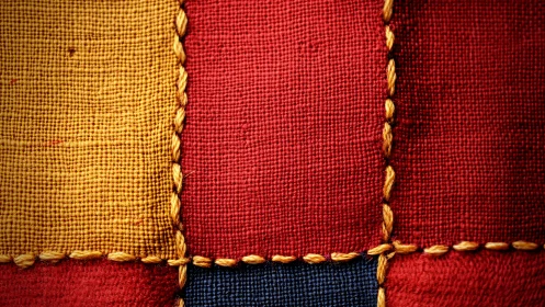 Macro study of woven fabric patchwork with contrasting stitch grid