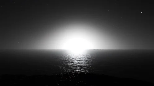 Monochrome seascape horizon with radiant central light source.