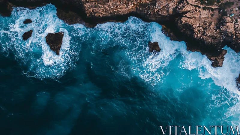 Aerial surf crashes along rugged sunlit coastal cliffs.