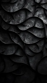 Layered dark curved surfaces forming abstract relief pattern.