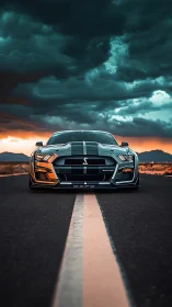 Bold muscle car waiting under stormy sunset skies.