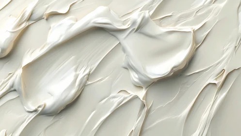 Smooth light-toned viscous material forms layered surface