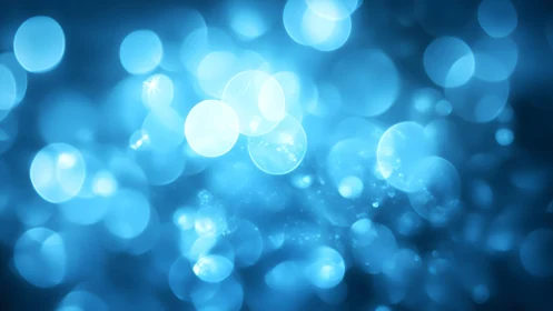 Abstract blue bokeh background with glowing circular light effects.