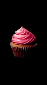 Elegant pink frosted cupcake with swirled icing on black backdrop