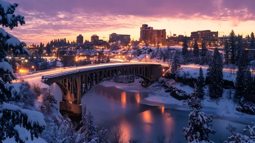 Snowy city bridge at dusk with warm urban lighting.